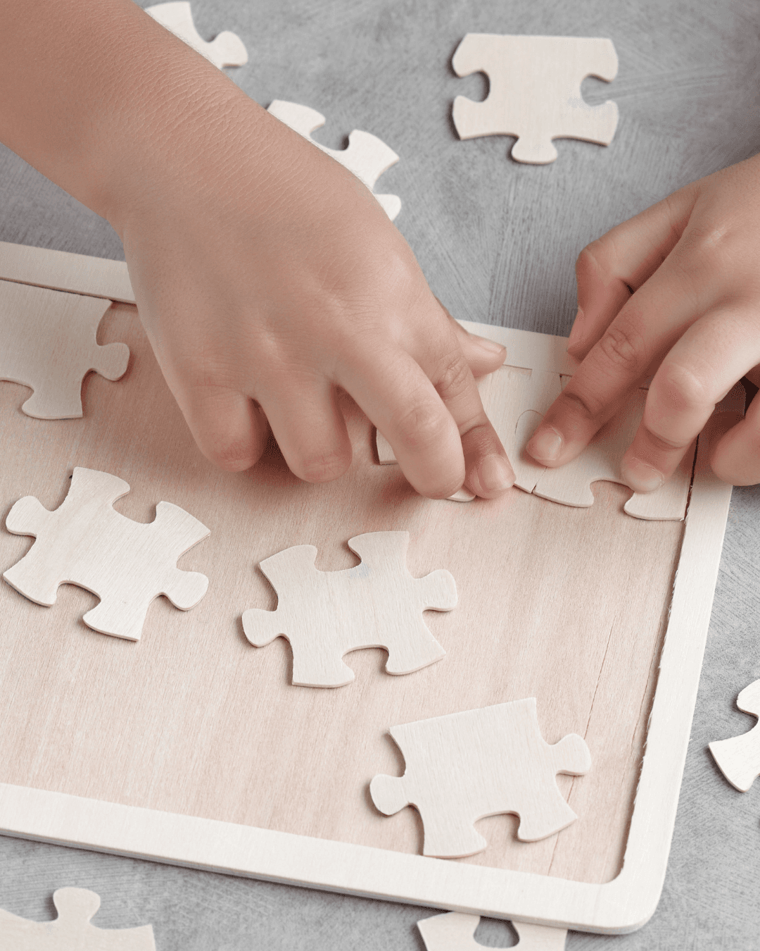 Child solving a wooden puzzle